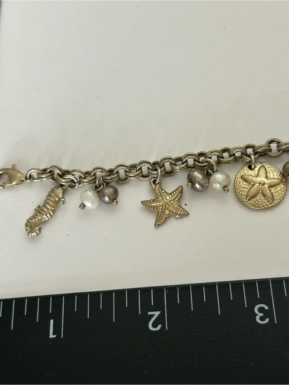 Gold-Tone Under the Sea Lia Sophia Seashell Charm Bracelet with Pearls (6) - Picture 4 of 6